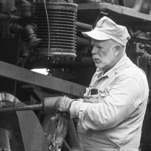 image of a conductor on a train performing maintenance