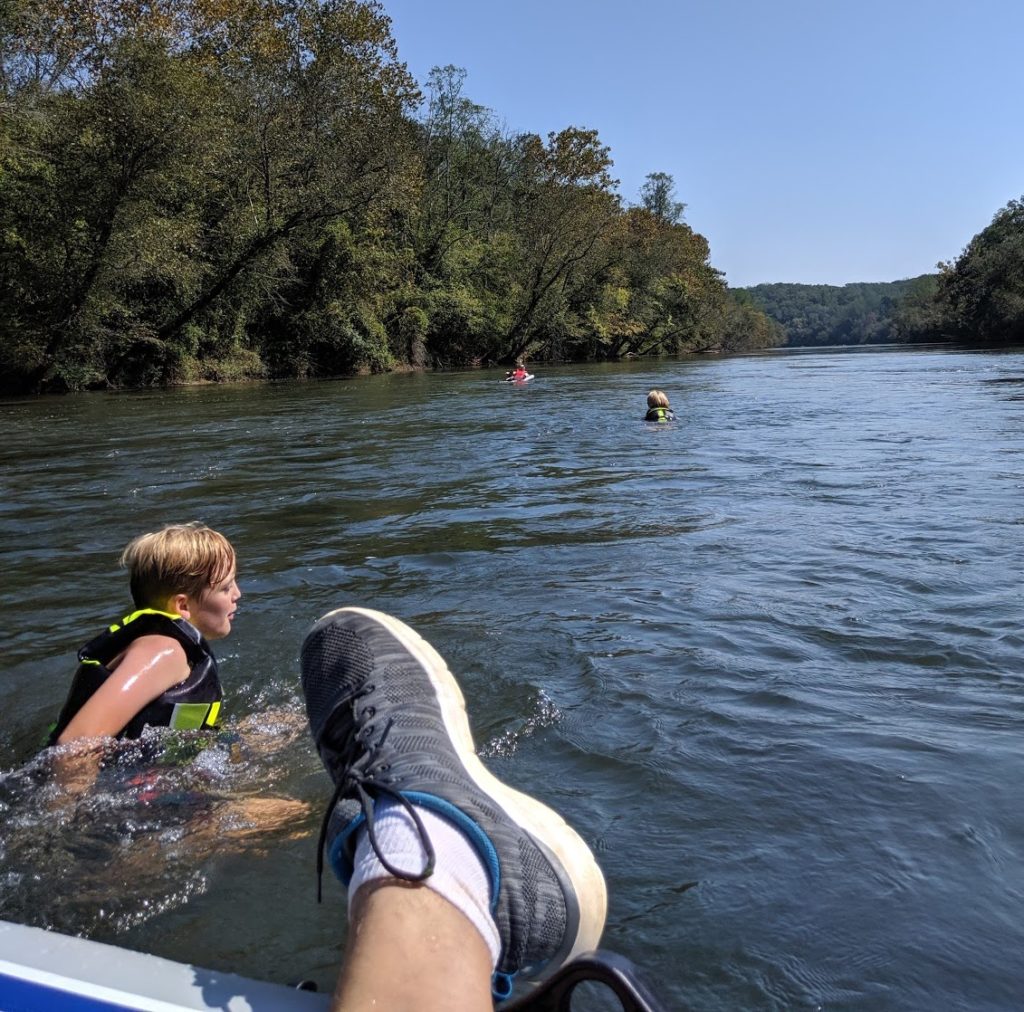 View from the boat with two children and wife floating in the distance.